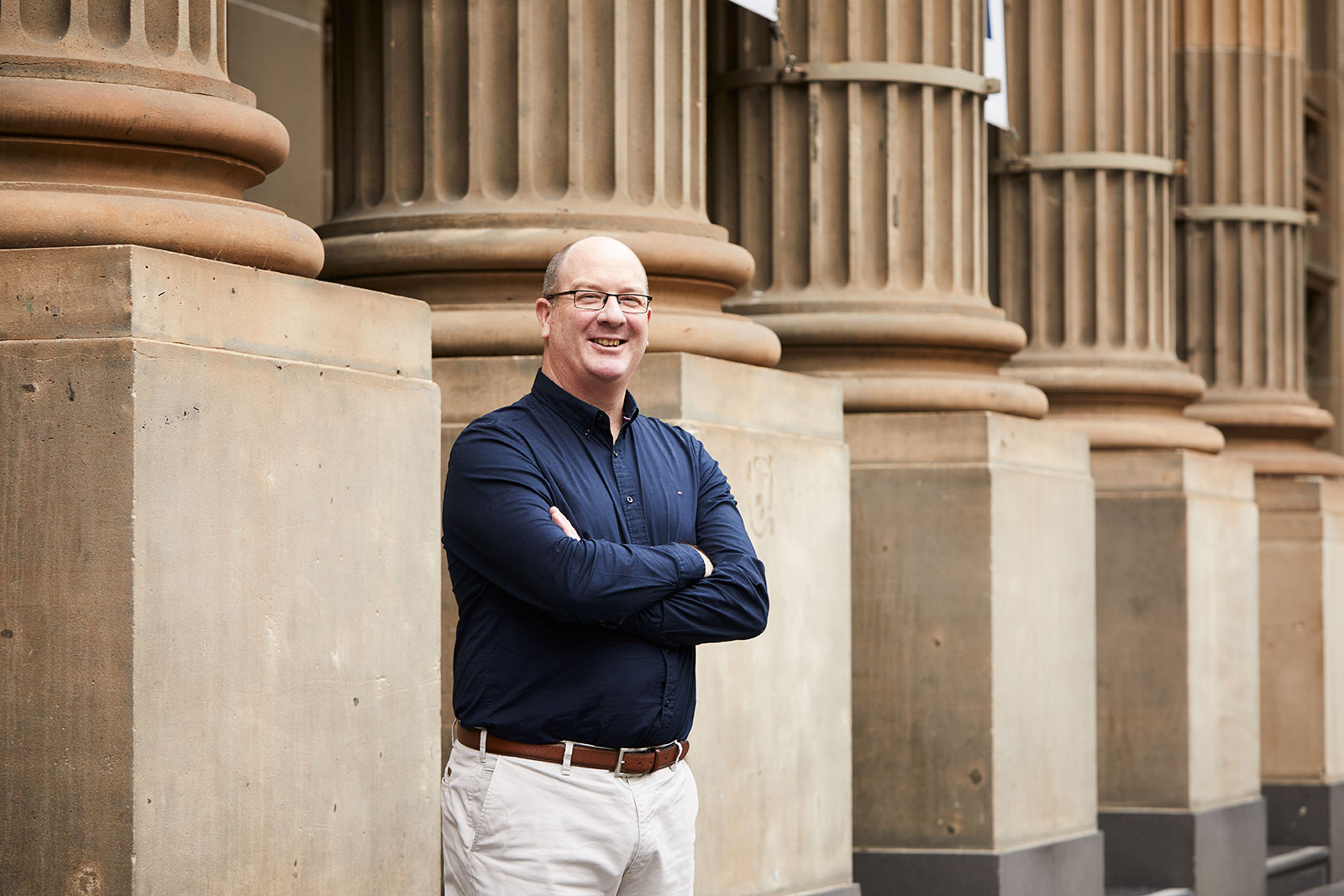 Greg Harrison, RPS  Victorian Lead for Strategy and Investment stands in front of Pillars outside the State Library of Victoria in Melbourne CBS.