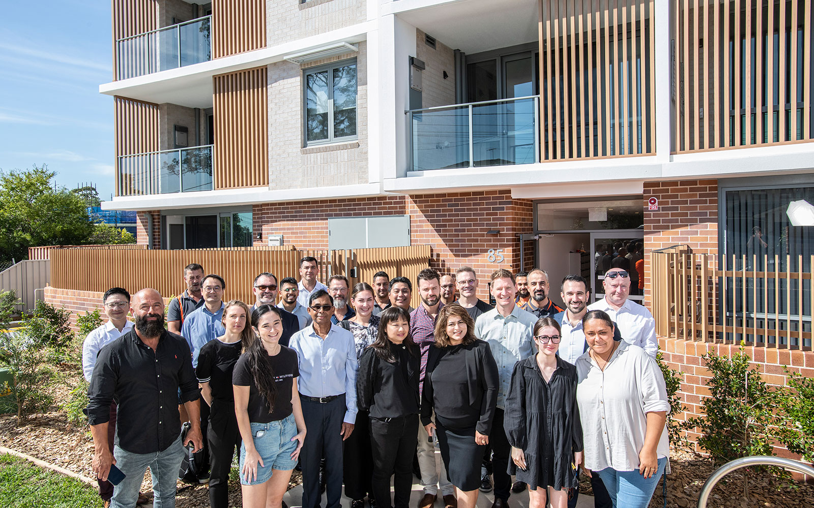 Project team standing in front of Waldron Road Chester Hill social housing development. Image credit: Homes NSW