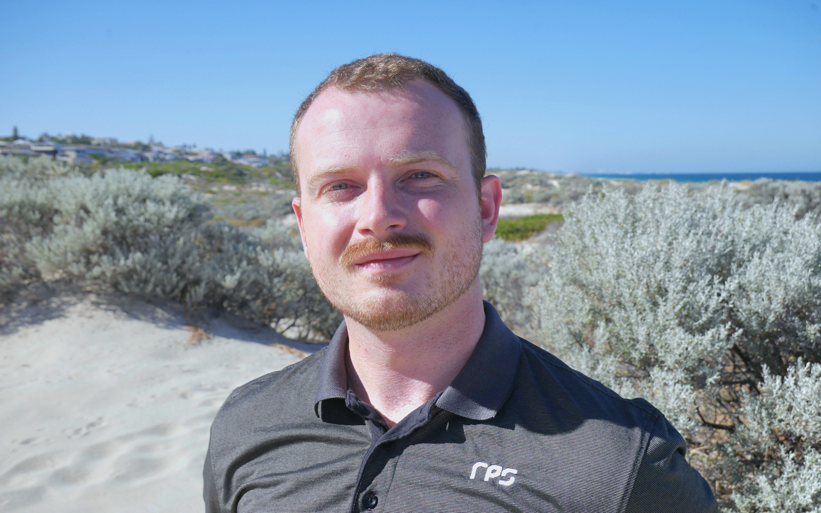 RPS Scientist Ciaran Carolan soaks up the sun at his local beach in Scarborough, Perth